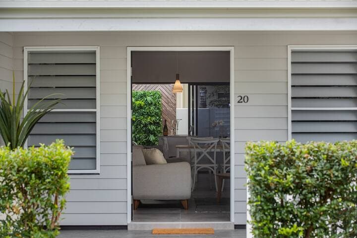 The front door opens wide to reveal a tastefully designed and furnished living space, just perfect for a relaxing vacation.