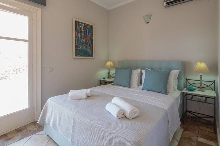 Bedroom 2: On the upper level, with double bed and full height window with garden and sea views