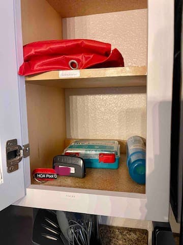 First aid kit, and fire blanket - top left cabinet by stove
