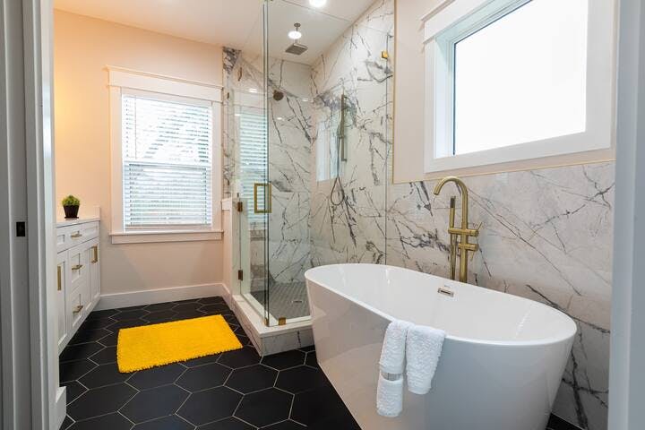 Bathroom 1: Indulge in luxury in the large en-suite master bath with designer accents and marble. Relax in the spacious soak-in tub or enjoy the refreshing large glass shower with multiple rain spouts. Truly spa like and luxury.
