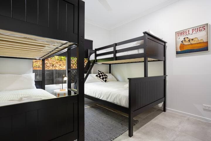 Bedroom 2 fully air conditioned with a mirrored robe has 2 bunk beds: 3 singles and a double
