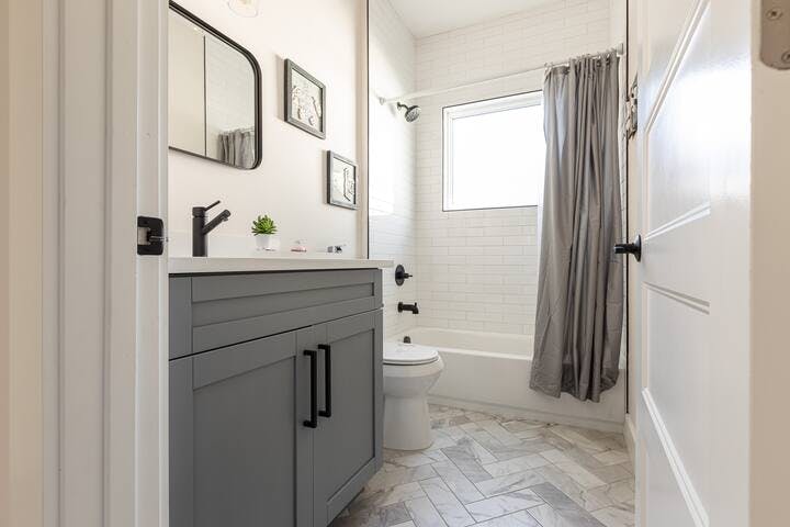 Bathroom 2: Convenience meets comfort with a second full bathroom featuring a tub, shower, & spacious vanity. Easily accessible from bedrooms & the living room. Hair & body products are thoughtfully provided for your convenience & added comfort.