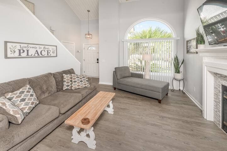 Unwind and relax in the cozy ambiance of the fireplace, large flat-screen Amazon Fire TV, high ceilings and natural light.