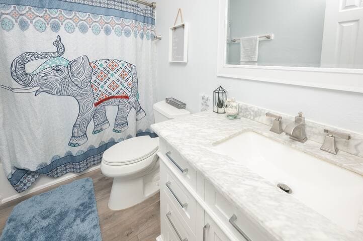 The upstairs full bath has a removable showerhead and a stainless steel, double-curved shower rod for more space.