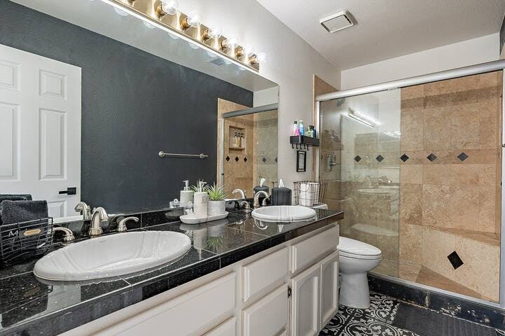 Bathroom 2, conveniently located off the main hallway near the bedrooms, features dual sinks and a refreshing shower.