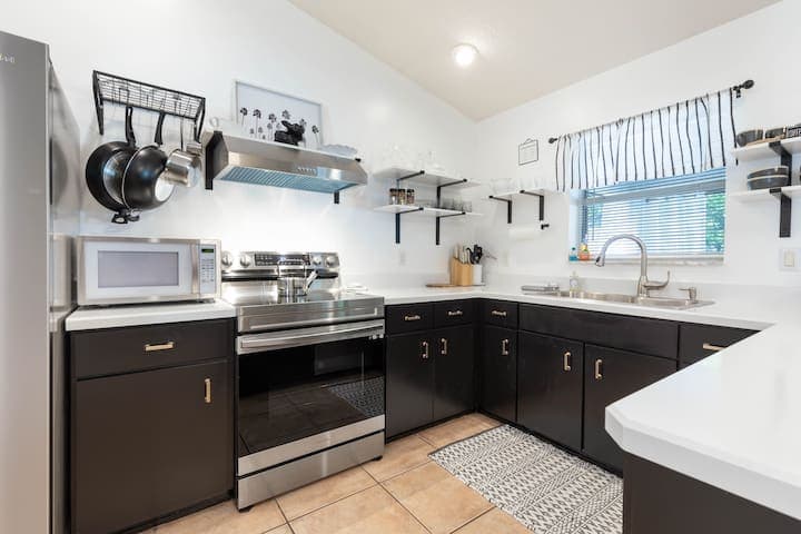 Another view of the kitchen which shows the new microwave and new stove which also has an AirFry feature built in. Your chicken wings fry up nicely!
Tea kettle also provided for our tea lovers!