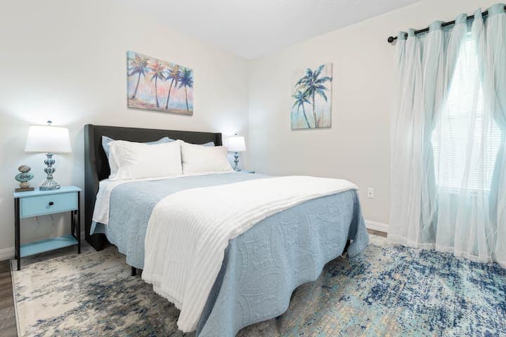 3rd bedroom is airy and fresh with a queen size bed and views of the back yard.
