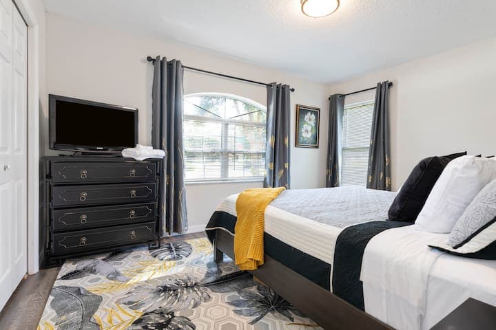 Well appointed 2nd bedroom with King bed, flat screen tv setup for streaming with views into the front yard.