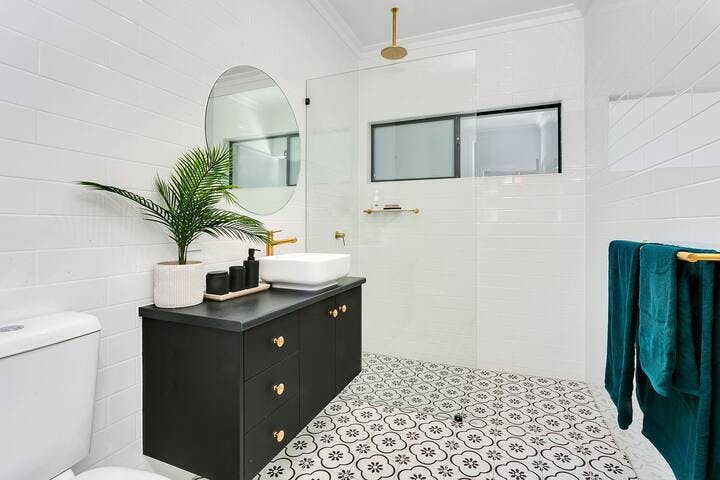 You will love this stunning light-filled bathroom with an awesome rain shower feature and Moroccan style floor tiles. We also supply Shampoo, Conditioner and Body Wash. You'll even find a Hairdryer.