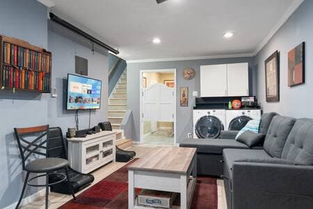 Living Room | Projector + Sofa Bed | Convertible Coffee Table Projector screen pulls down for movies. Coffee table lifts to dining height for 3–4 to eat or play games. Sofa pulls out to sleep 2; extra bedding in chaise. Full washer and dryer in unit.