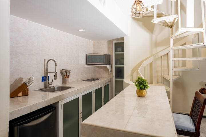 Kitchen has a mini fridge that is large enough for beer, soda, water and a light run to the grocery store. Also includes microwave, stove top (2 burners), blender, toaster, coffee maker.