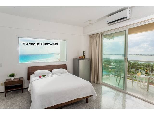 Second bedroom features 1 queen bed and 1 futon with an amazing view of the beach and lagoon from the balcony and inside the condo. Has an attached bathroom. Black out curtains installed