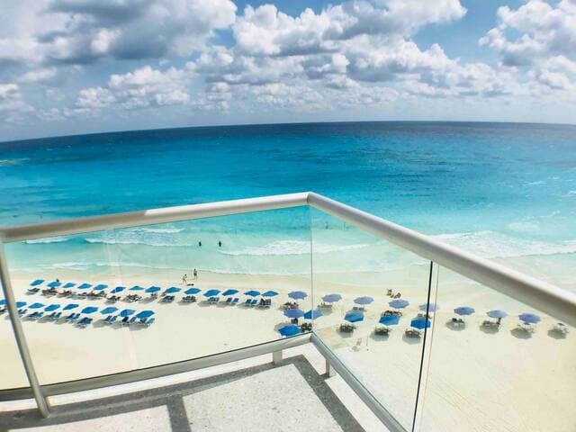 Amazing view from 1st bedroom patio. Wrap around balcony. We provide an umbrella and chairs. The umbrella vendor is in this photo is no longer there.