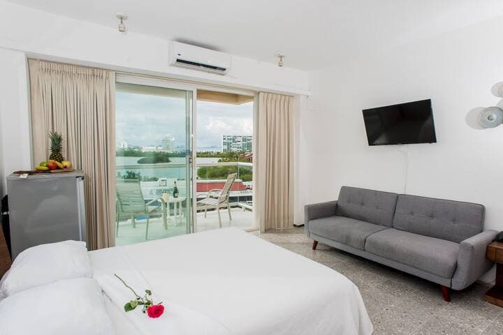 View of second bedroom including futon. The room also has a fridge.