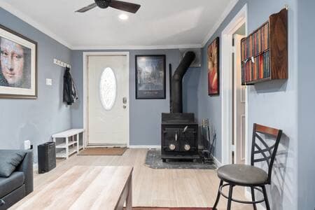 Entry | Wood Stove + Coat Rack | Air Filter + Luggage Rack Cozy wood-burning stove with firewood. Coat and shoe racks for storage. Air purifier keeps things fresh. Luggage rack and lamp now included (lamp not pictured).