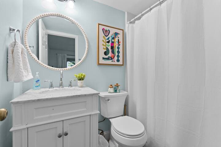 Full en-suite bathroom with tub and shower.