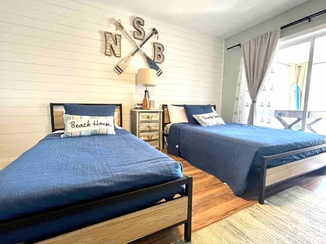 Third bedroom features a full-sized bed, twin bed and Smart TV. Slider doors lead to the recreation room.