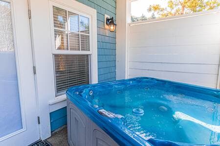 Private hot tub is around the back of the house, with door to additional king bed/bath to the left, in photo.