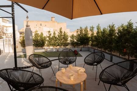 Shared rooftop gym on the 4th floor—(same umbrellas), open to all guests.
Your private garden waits just outside your suite downstairs.