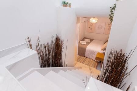 The bedroom is located on the lower level and features Cycladic-inspired design, with its own wardrobe, safe box, and air conditioning, combining island charm with modern comfort.