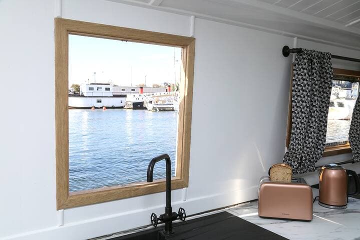 View of the hatch behind the sink in the kitchen. View of marina in the background