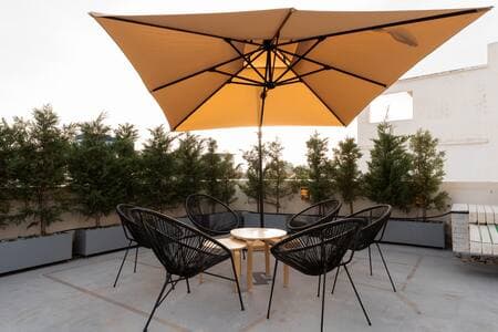Shared rooftop gym on the 4th floor—(same umbrellas), open to all guests.
Your private garden waits just outside your suite downstairs.